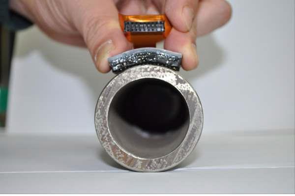 Photo of polymer based flexible phased ultrasonic transducer applying to small pipe specimen