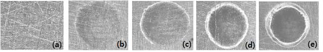 SEM micrographs of CO2 + system according to the variation of fluence, 30X, (a) before irradiation, (b) 7.49 J/cm2, (c) 9.7 J/cm2, (d) 13.26 J/cm2, (e) 19.23 J/cm2, (14 shots/sec, 6 sec, 8 ns)