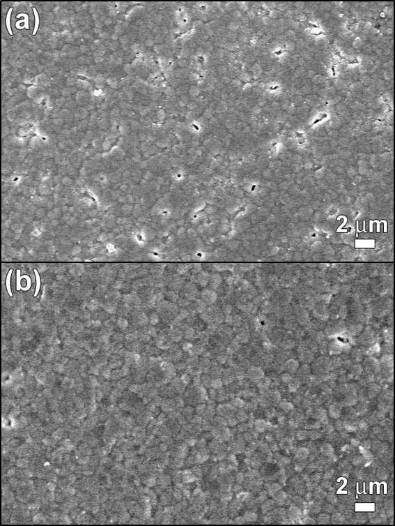 Top-view SEM images of electrolyte layers sintered at (a) 1350 °C and (b) 1400 °C.