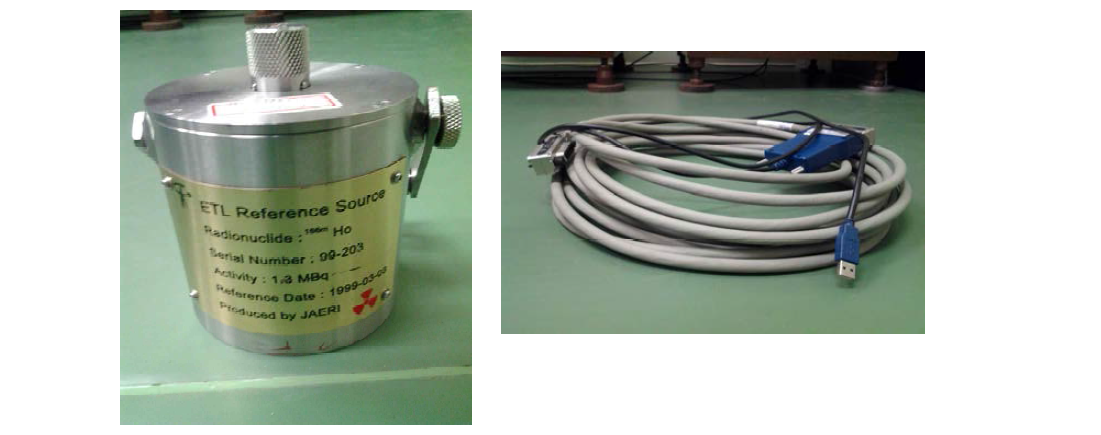 Ho-166m source for checking the travelling standard (left) and the long GPIB cable used on site.