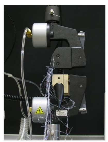 Apparatus for measurement the breaking load and elongation of monofilament samples.
