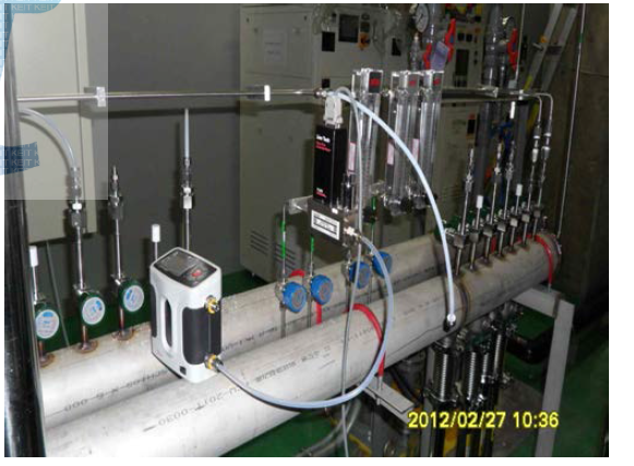 (b) Photograph of flow control system at the fab