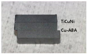 Stacked SiC joint sample with TiCuNi and Cu-ABA interlayers.