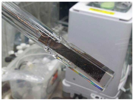 Photo of the tungsten electrode in molten LiCl-KCl after electrodeposition of Np