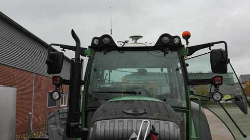 The auto-guided tractor equipped with RTK-GPS, the big white antenna in the middle, and D-GPS, the small white antenna next to the RTK-GPS