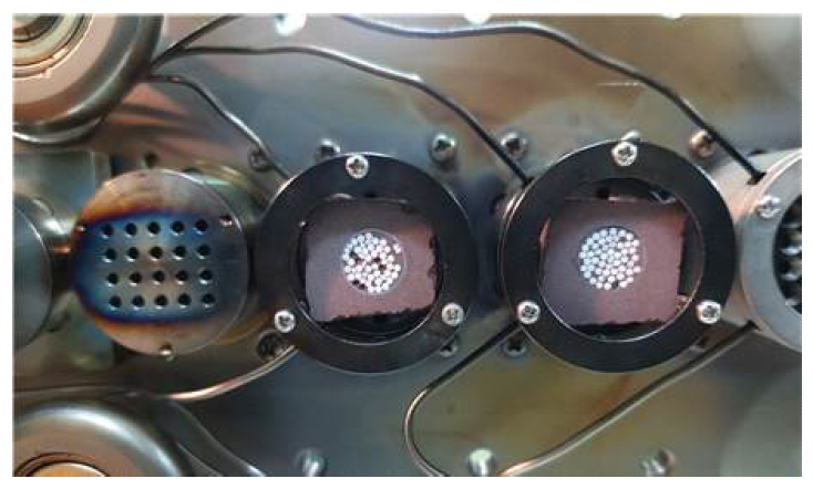 Photo of Li2TiO3 pebbles mounted on sample holders of the accelerator