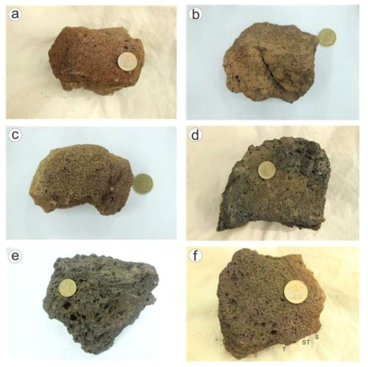 Typical scoriaceous lapilli and bomb fragment collected from the lower and upper parts of the Jugam Scoria Deposits. (a) S-type scoriaceous lapillus showing fine vescles; (b) S-type scoriaceous lapillus with fluidal surface; (c) ST-type scoriaceous lapillus, with vesicles coarsening from rim to interior; (d) T-type scoriaceous lapillus with some coarse vesicles; (e) T-type scoriaceous lapillus consisting of coarse vesicles; (f) Scoriaceous bomb fragment showing separately quantified textural zones S, ST and T. Similar divisions were made, but are not shown for the other clasts